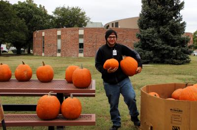 Kyle holding two pumpkins. 