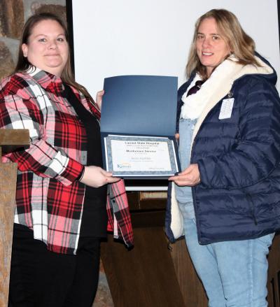 Superintendent Lindsey Dinkel presents Meritorious Service award to Janice VanDam.